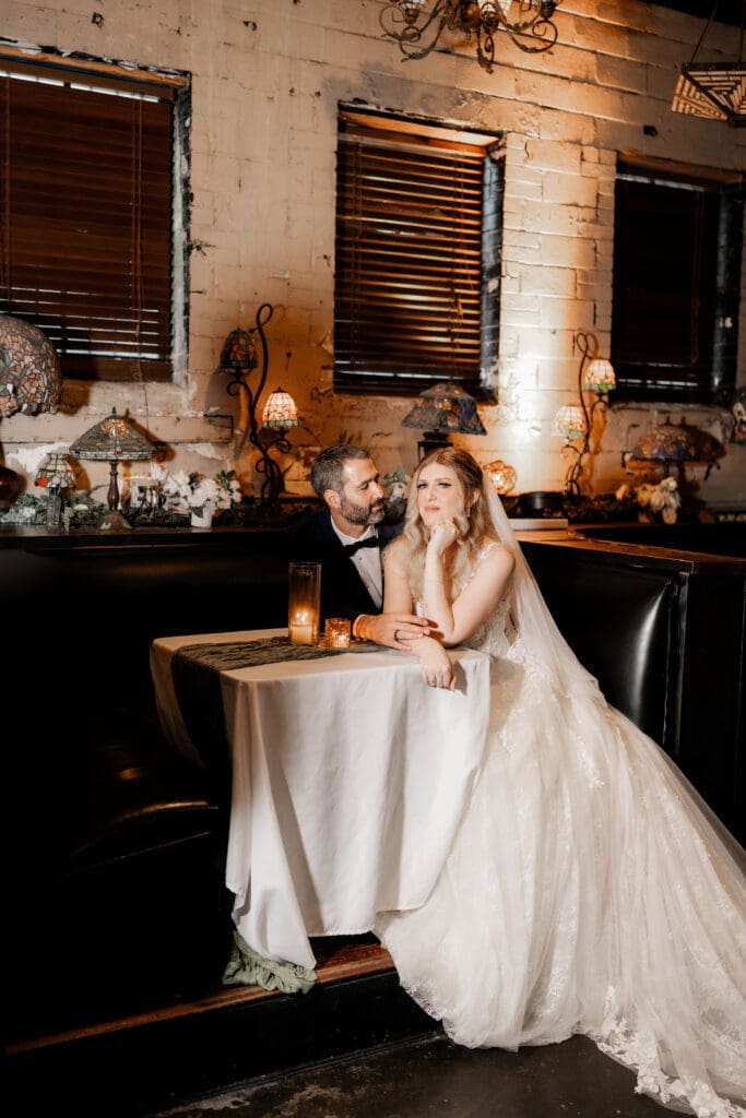 Bride and groom's moody indoor portraits at their Nouveau Antique Bar wedding in Houston, TX