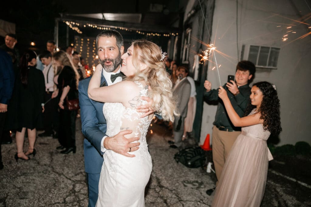 Bride and groom's grand sparkler exit outside the Nouveau Antique Art Bar