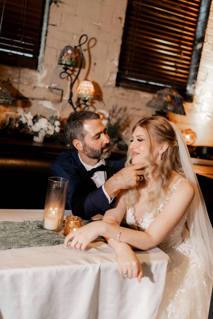 Bride and groom's moody indoor portraits at their Nouveau Antique Bar wedding in Houston, TX