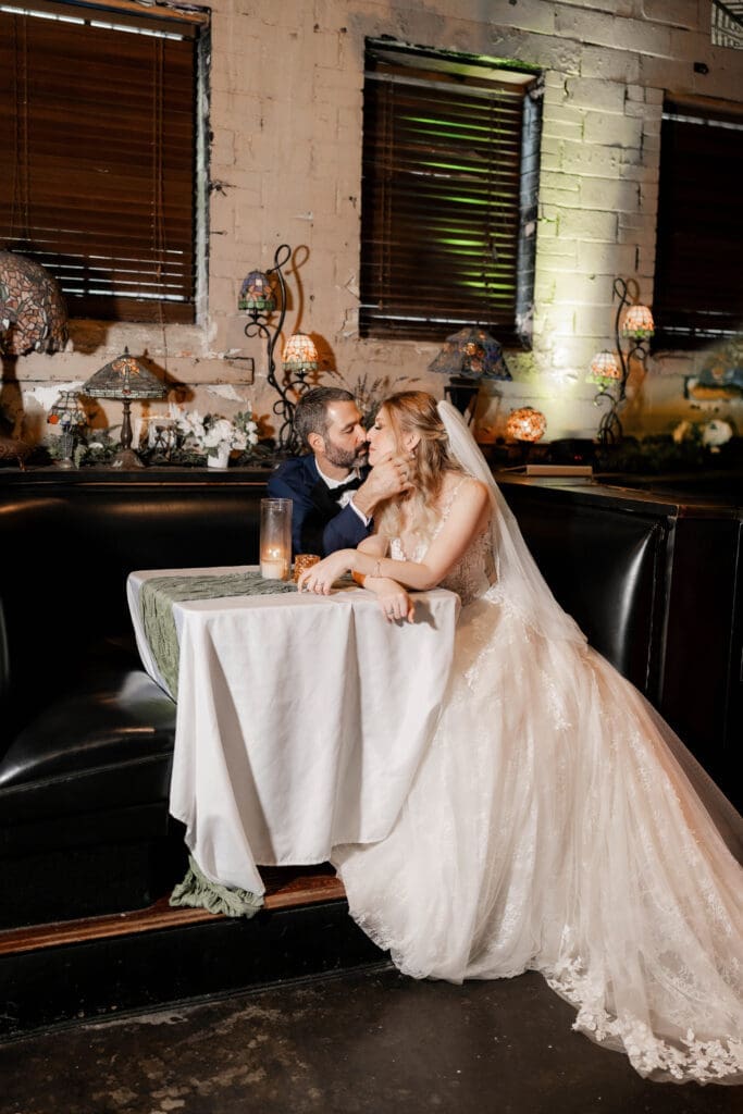Bride and groom's moody indoor portraits at their Nouveau Antique Bar wedding in Houston, TX