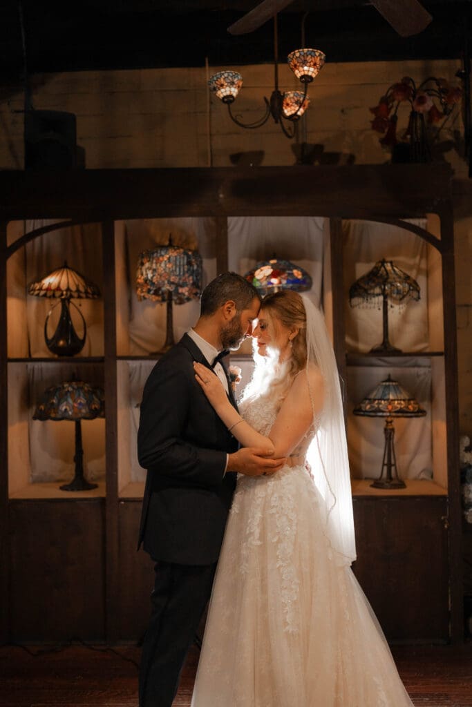 Bride and groom's moody indoor portraits at their Nouveau Antique Bar wedding in Houston, TX