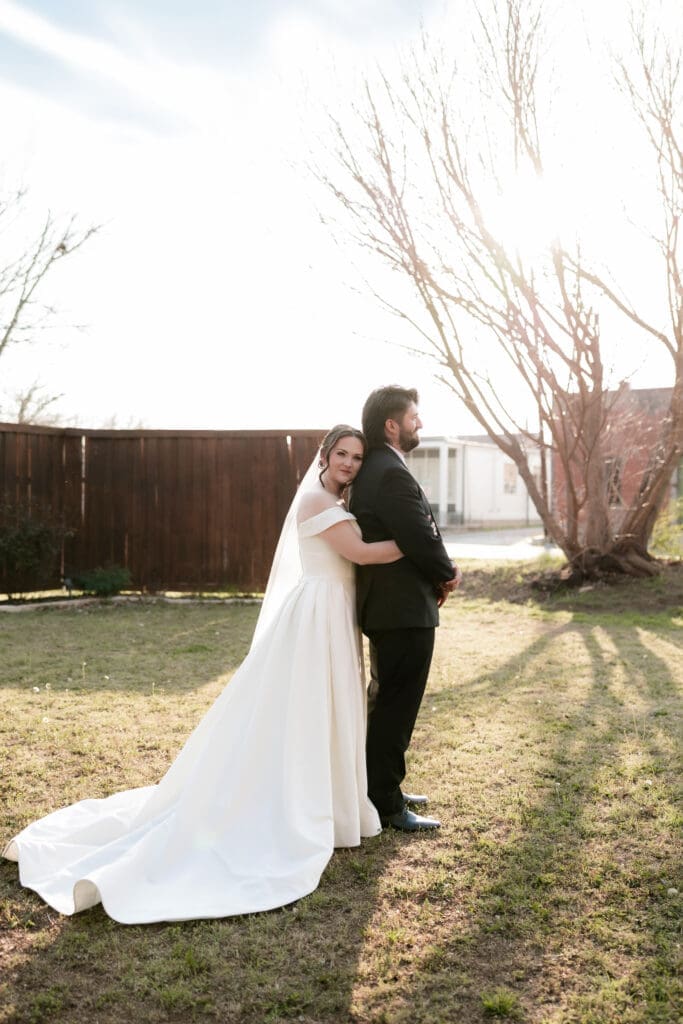 Bride and groom taking wedding portraits at The 1906 wedding venue in Whitesboro, TX