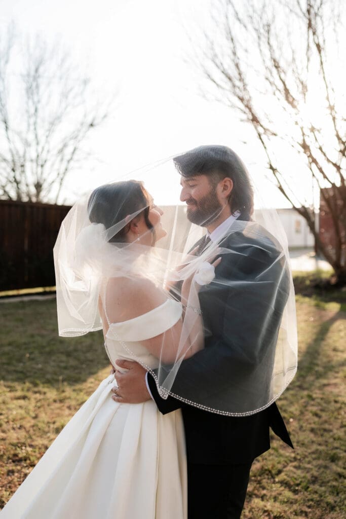 Bride and groom taking wedding portraits at The 1906 wedding venue in Whitesboro, TX