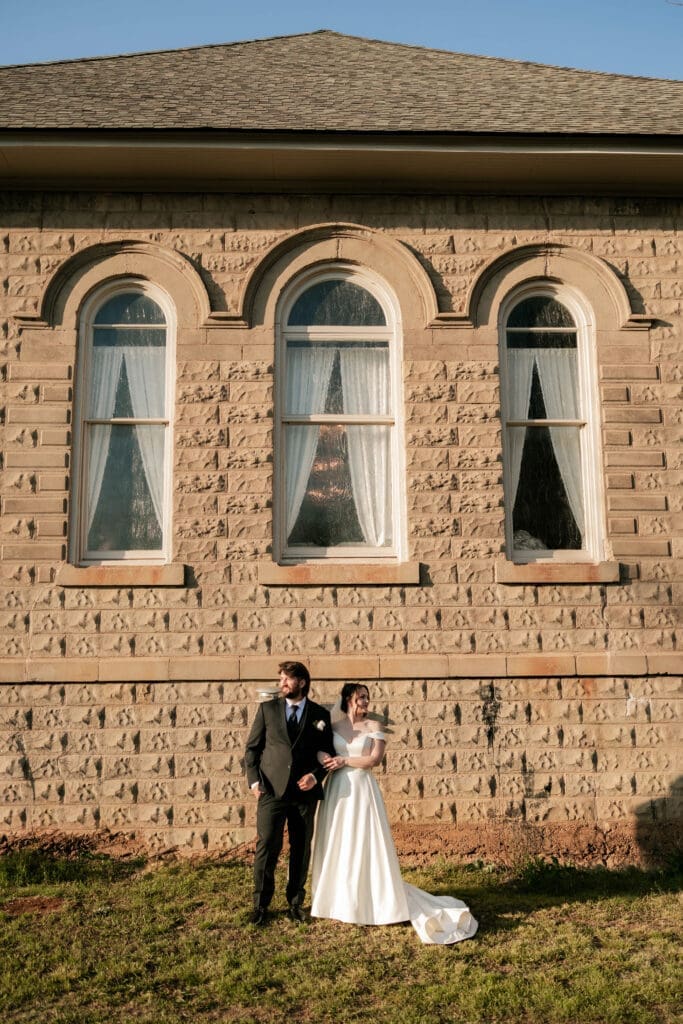 Bride and groom taking wedding portraits at The 1906 wedding venue in Whitesboro, TX