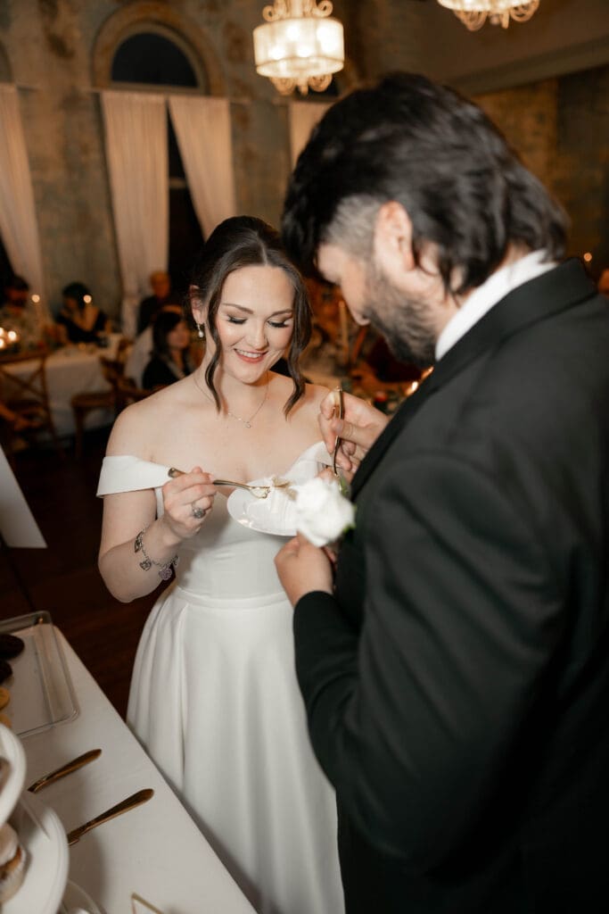 Bride and groom cutting their cake at The 1906 wedding venue in Whitesboro, TX