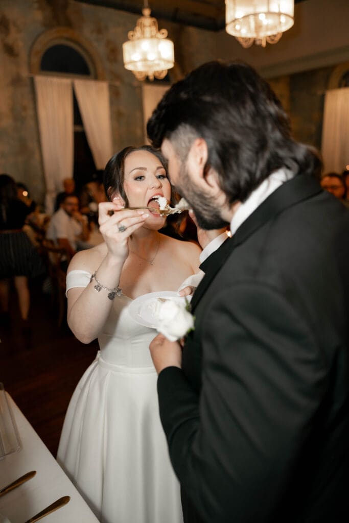 Bride and groom cutting their cake at The 1906 wedding venue in Whitesboro, TX