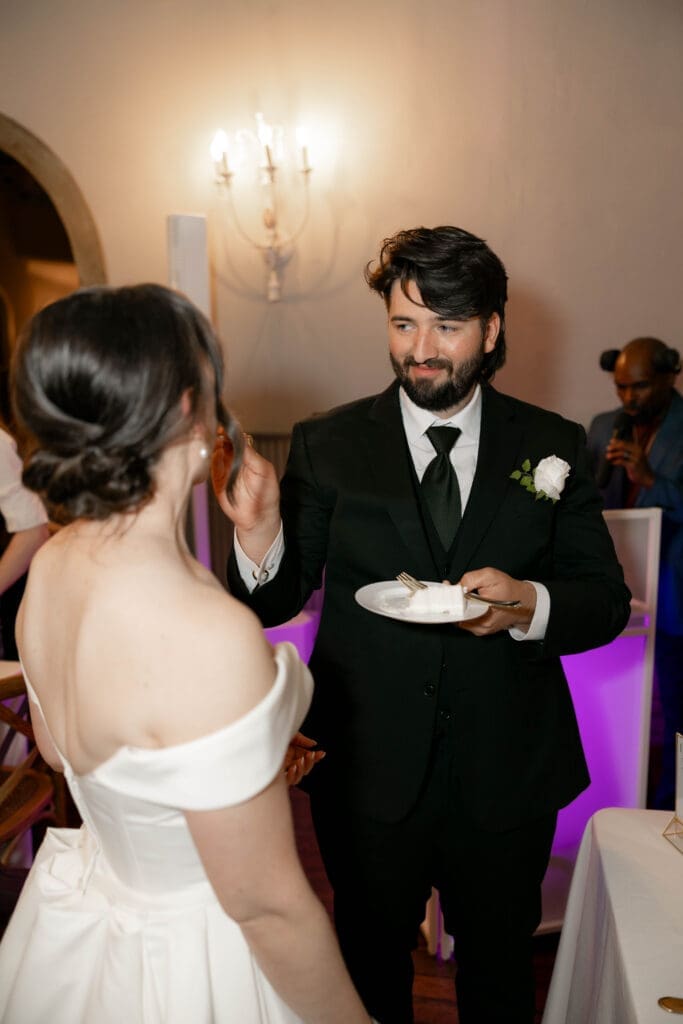 Bride and groom cutting their cake at The 1906 wedding venue in Whitesboro, TX