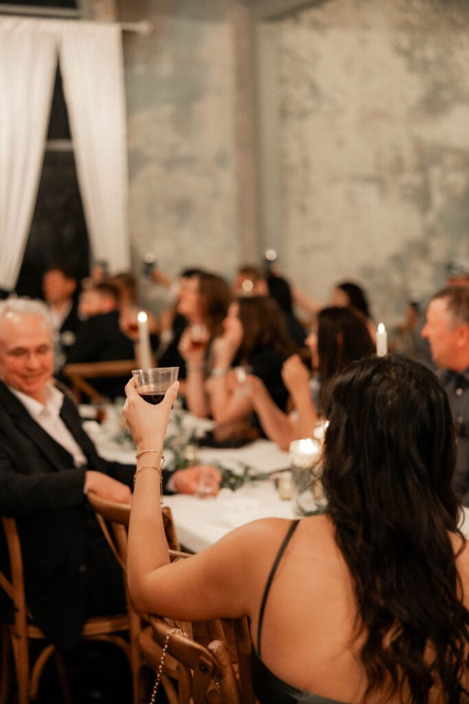Guests cheersing at The 1906 wedding venue in Whitesboro, TX