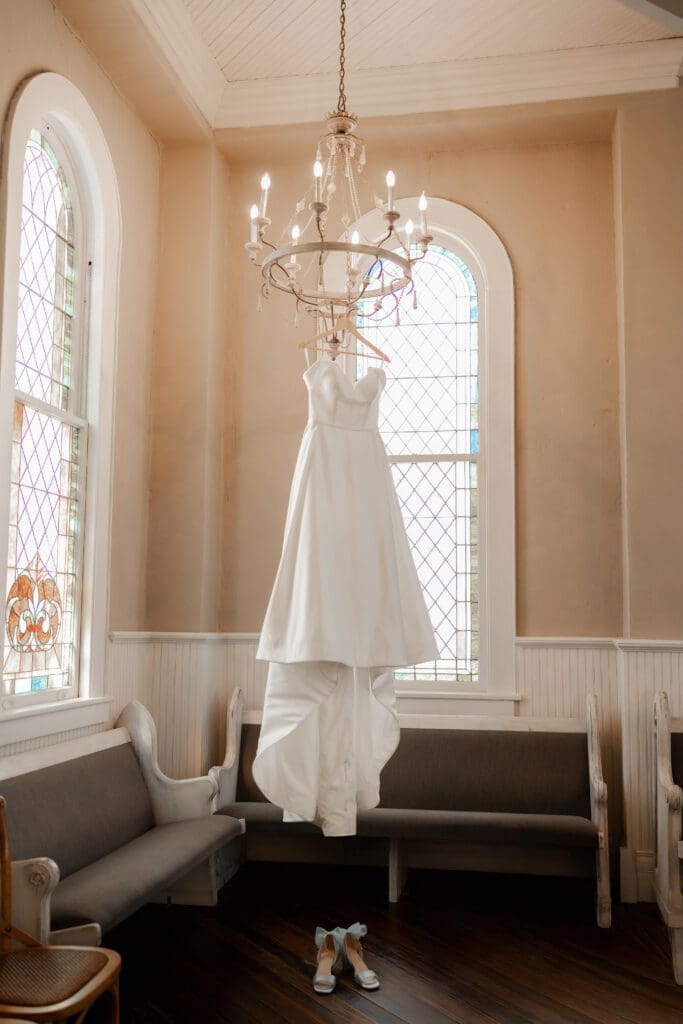 Dress hanging from chandelier photos at The 1906 wedding venue in Whitesboro, TX