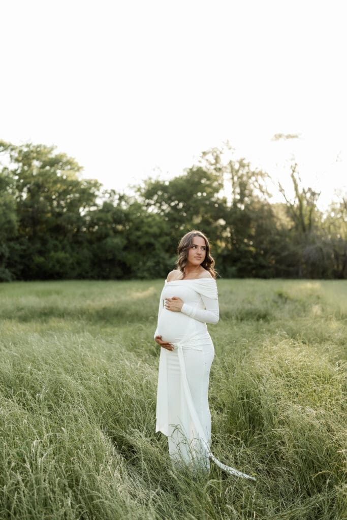 Woman posing in grassy field during her golden hour Airfield Falls Maternity session