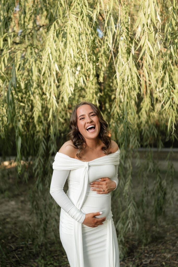 Woman laughing in front of the willow tree at Airfield Falls Park