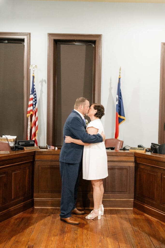 Michelle and Jason kiss during their Wedding ceremony inside the historic Weatherford courthouse