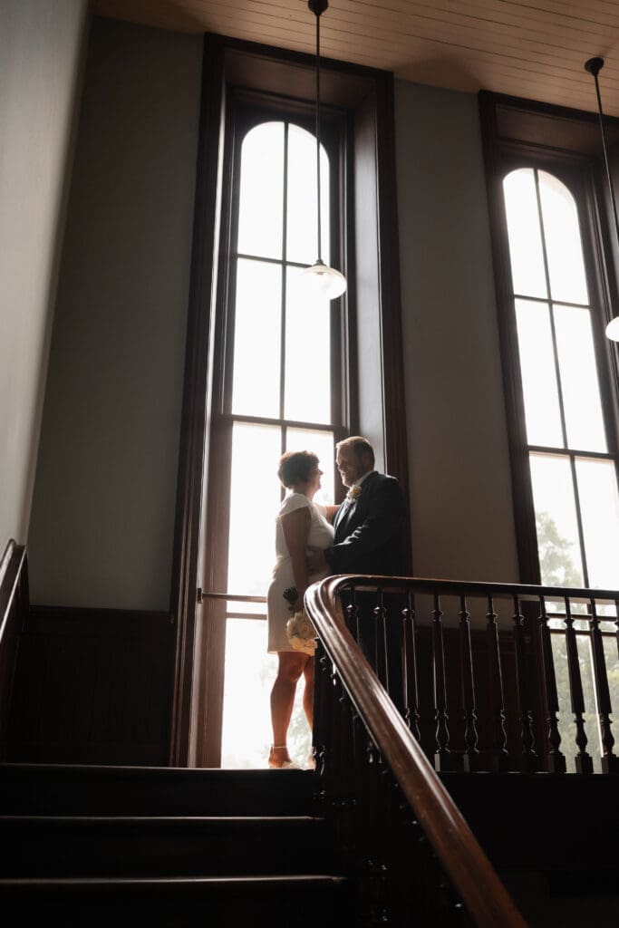 Bride and groom posing for silhouette portraits during their Downtown Weatherford Elopement 