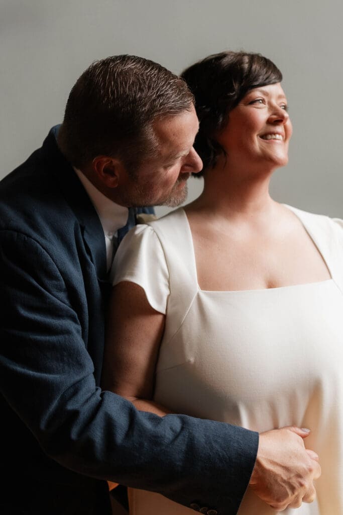 Bride and groom posing for portraits during their Downtown Weatherford Elopement 