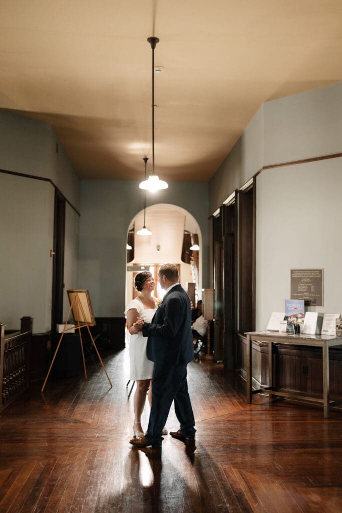 Bride and groom posing for portraits during their Downtown Weatherford Elopement 