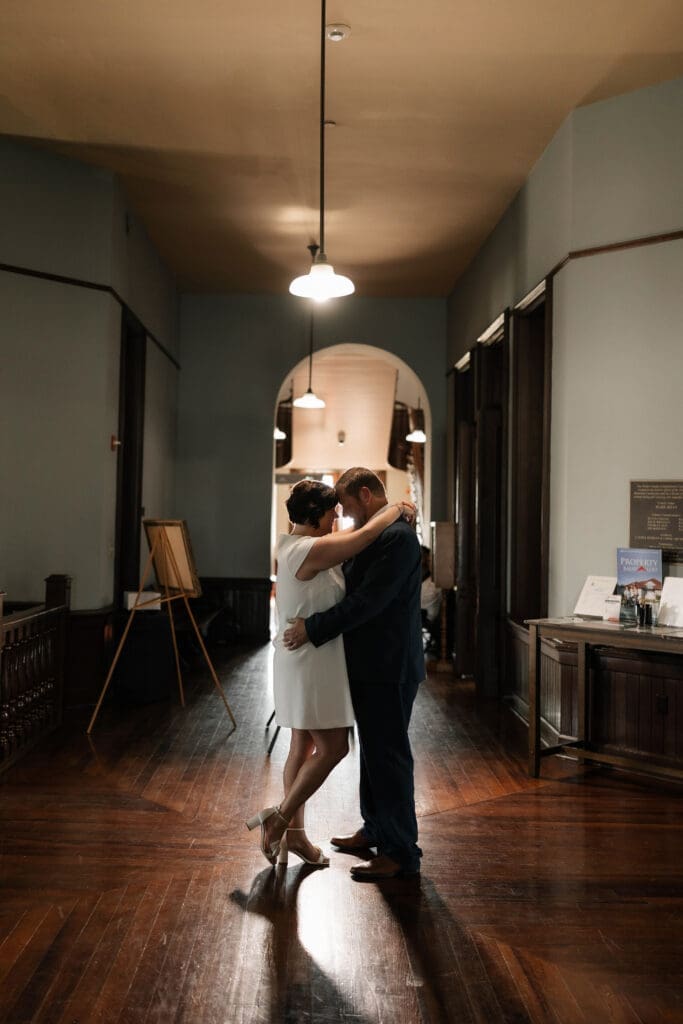Bride and groom posing for portraits during their Downtown Weatherford Elopement 