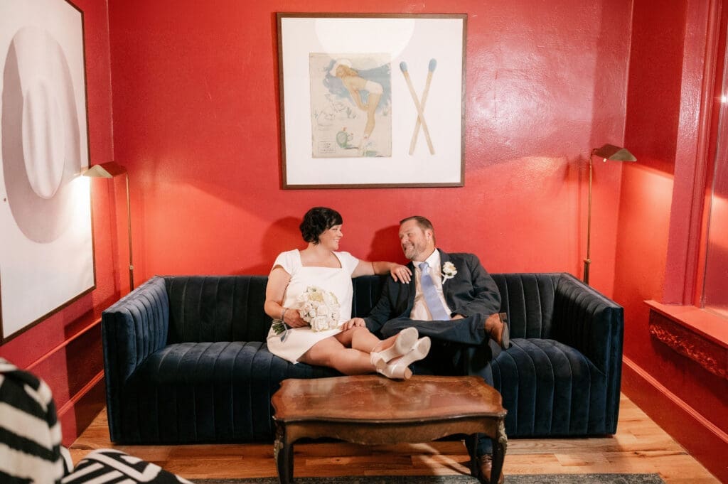 Bride and groom posing for portraits in the Jazz Chapel bar in downtown Weatherford TX