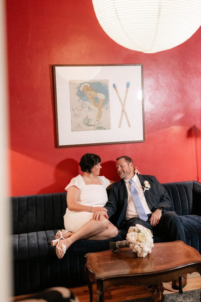 Bride and groom posing for portraits in the Jazz Chapel bar in downtown Weatherford TX