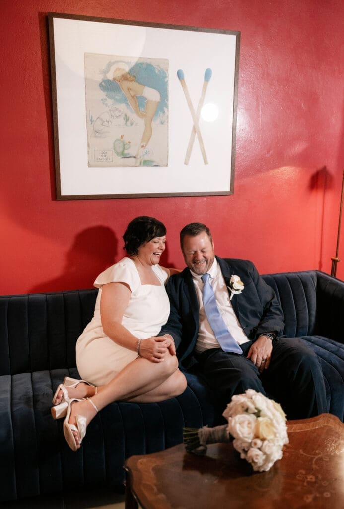 Bride and groom posing for portraits in the Jazz Chapel bar in downtown Weatherford TX