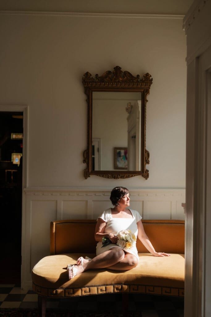 Bride posing for moody, dramatic lighting portraits in the foyer of the Jazz Chapel in downtown Weatherford TX