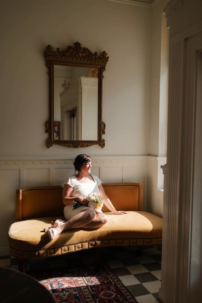Bride posing for moody, dramatic lighting portraits in the foyer of the Jazz Chapel in downtown Weatherford TX