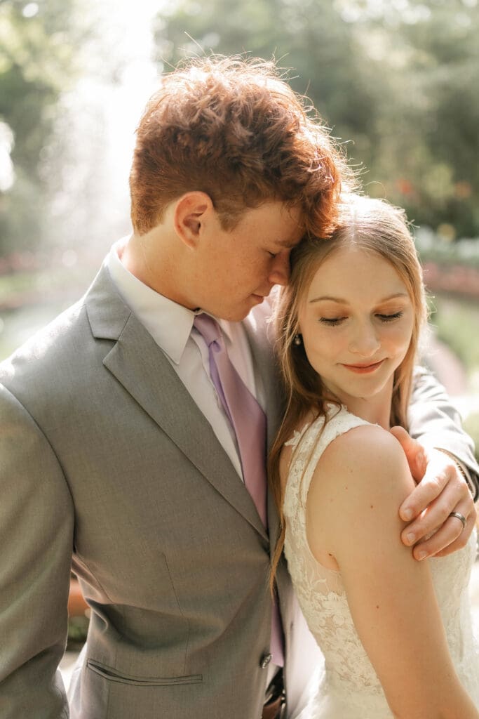 Bride and groom in front of fountain at Chandor Gardens in Weatherford, TX, during their wedding photography session