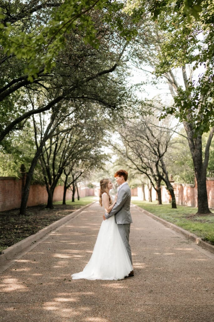 Bride and groom dancing at Chandor Gardens in Weatherford, TX, during their wedding photography session
