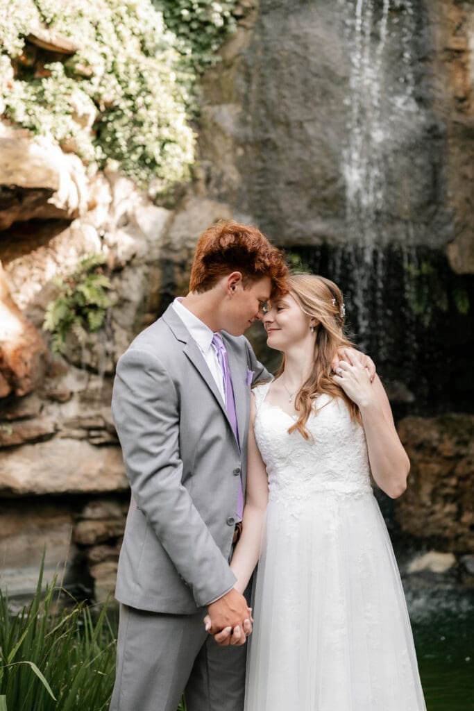 Bride and groom embracing at Chandor Gardens in Weatherford, TX, during their wedding photography session