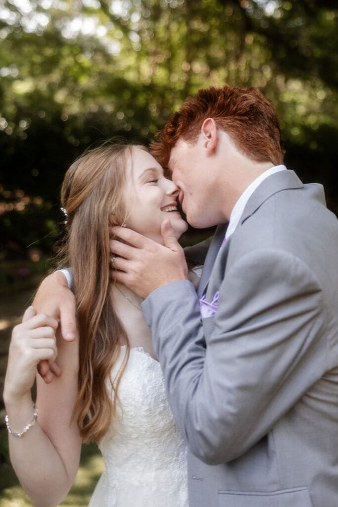 Bride and groom embracing for a kiss at Chandor Gardens in Weatherford, TX, during their wedding photography session