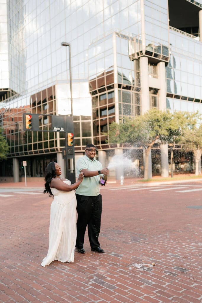Engaged couple popping prosecco in downtown Fort Worth