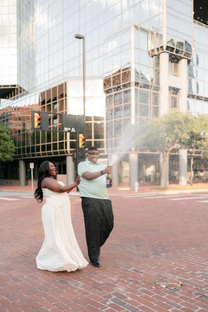 Engaged couple popping prosecco in downtown Fort Worth