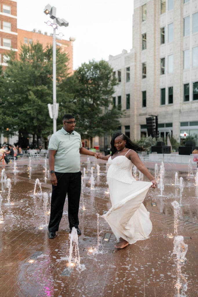 Couple dancing in the water fountain in Sundance Square