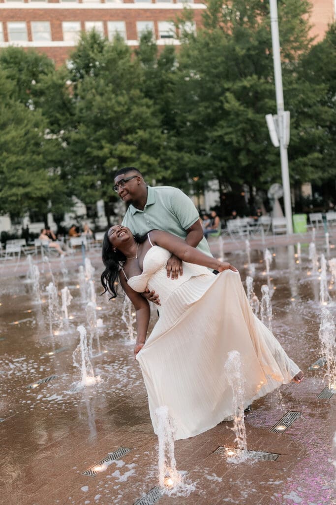Couple dancing in the water fountain in Sundance Square
