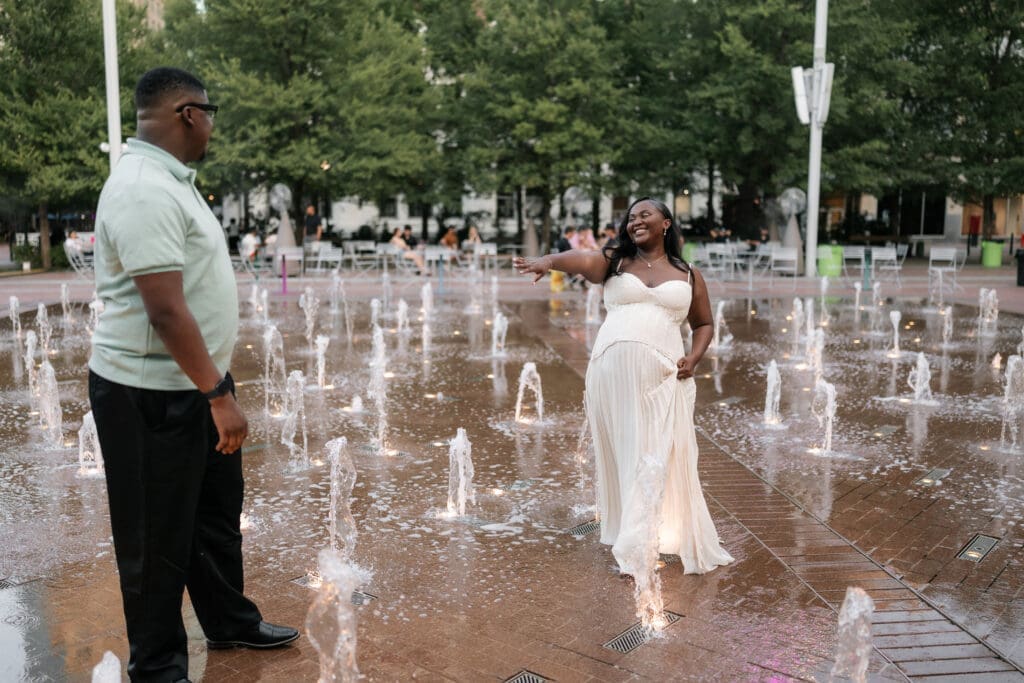 Couple dancing in the water fountain in Sundance Square