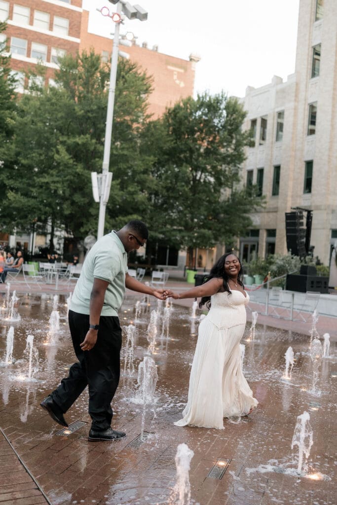 Couple dancing in the water fountain in Sundance Square