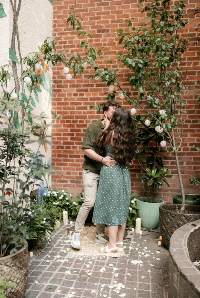 Man kissing his fiancé in Sundance Alley in Sundance Square, Fort Worht, TX