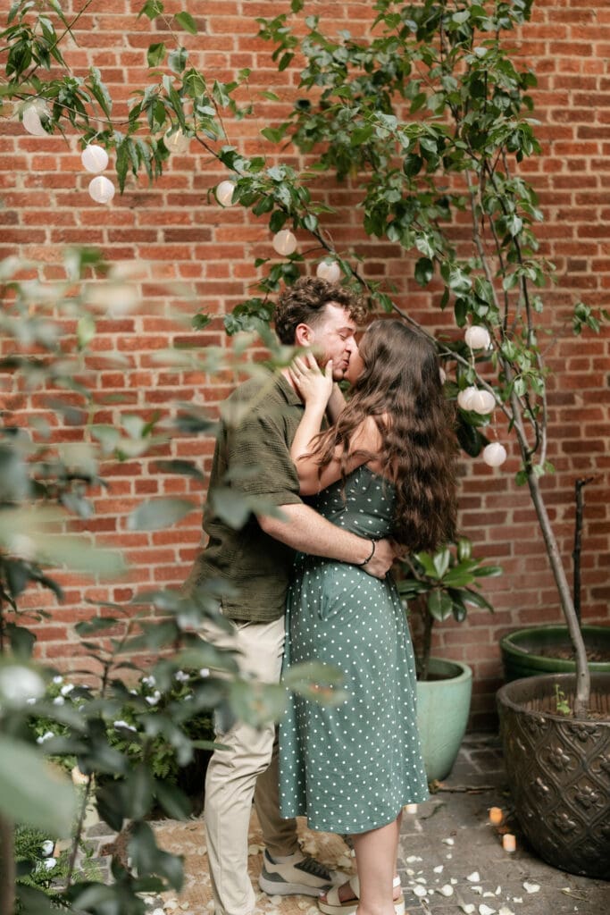 Man kissing his fiancé in Sundance Alley in Sundance Square, Fort Worht, TX