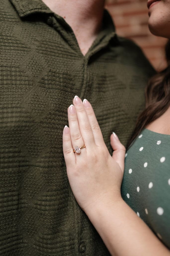 Man and woman embracing and kissing after he proposed to her in Sundance Alley in Sundance Square, Fort Worth, TX