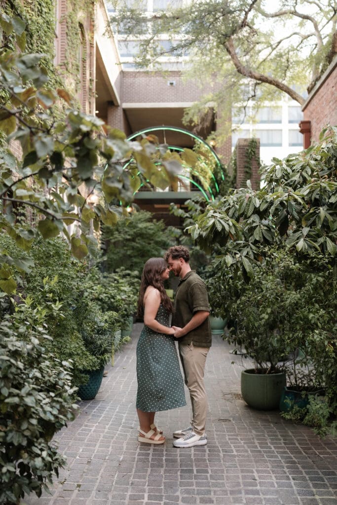 Man and woman embracing and kissing after he proposed to her in Sundance Alley in Sundance Square, Fort Worth, TX
