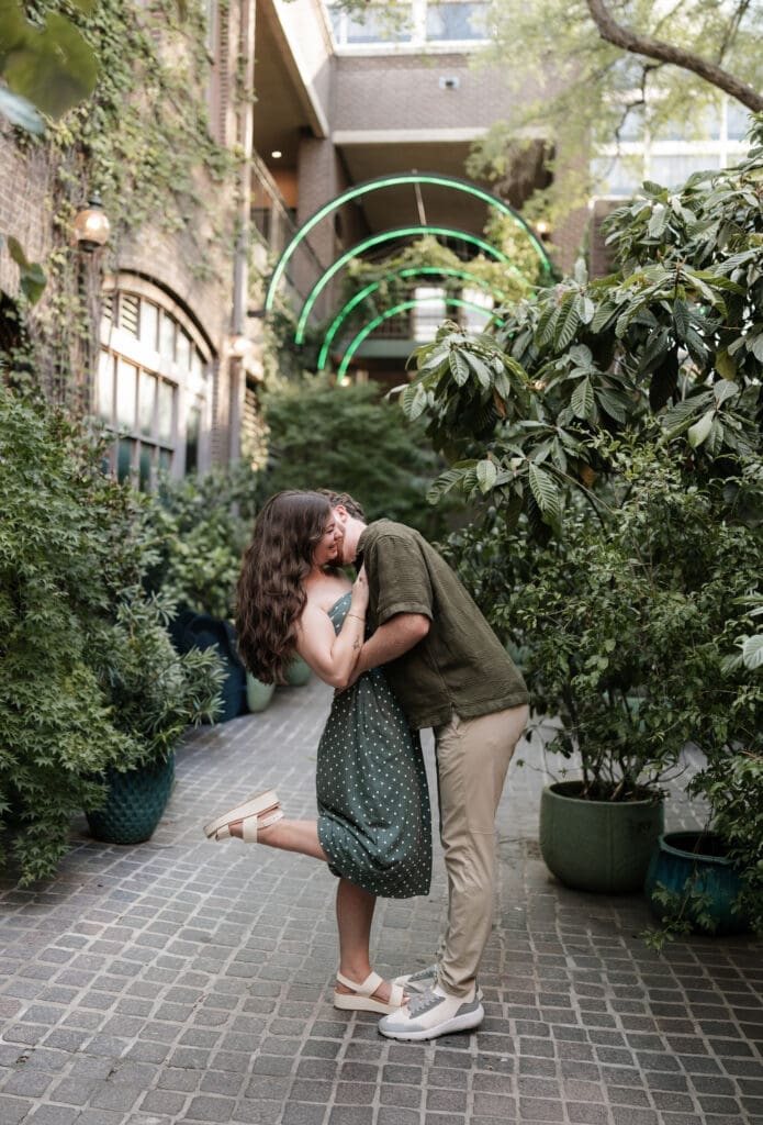 Man and woman embracing after he proposed to her in Sundance Alley in Sundance Square, Fort Worth, TX