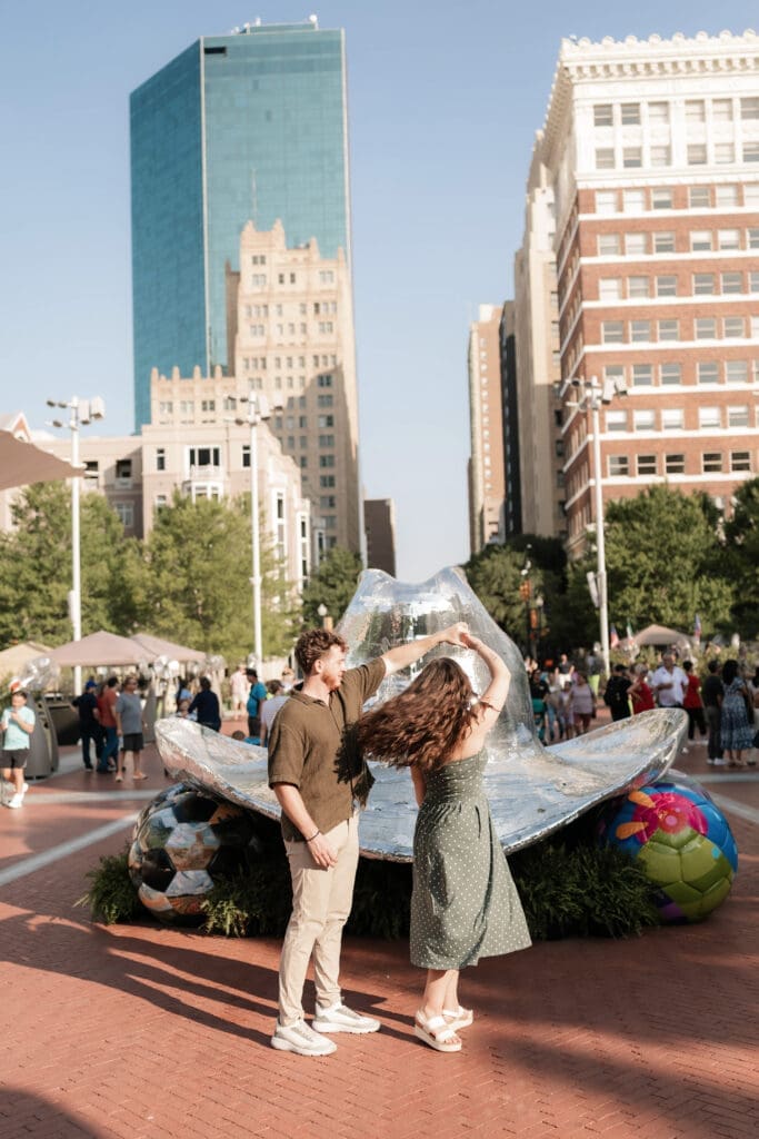 Man and woman dancing in front of the disco hat in Sundance Square