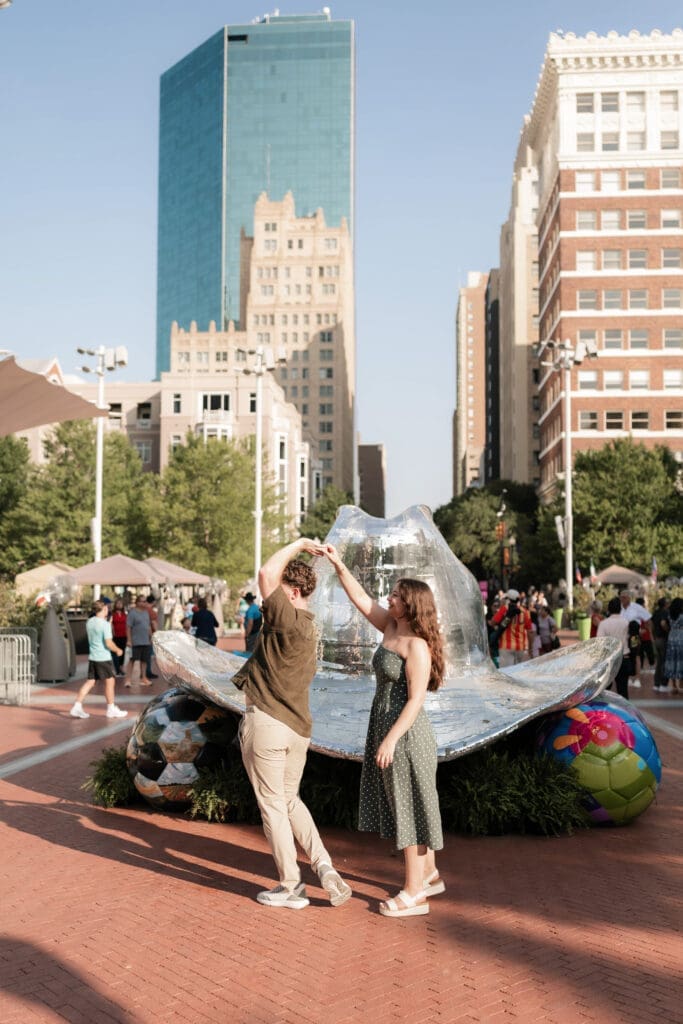 Man and woman dancing in front of the disco hat in Sundance Square
