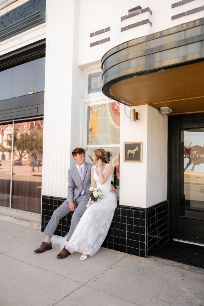 Bride and Groom embracing in front of Jazz Chapel in Downtown Weatherford, TX