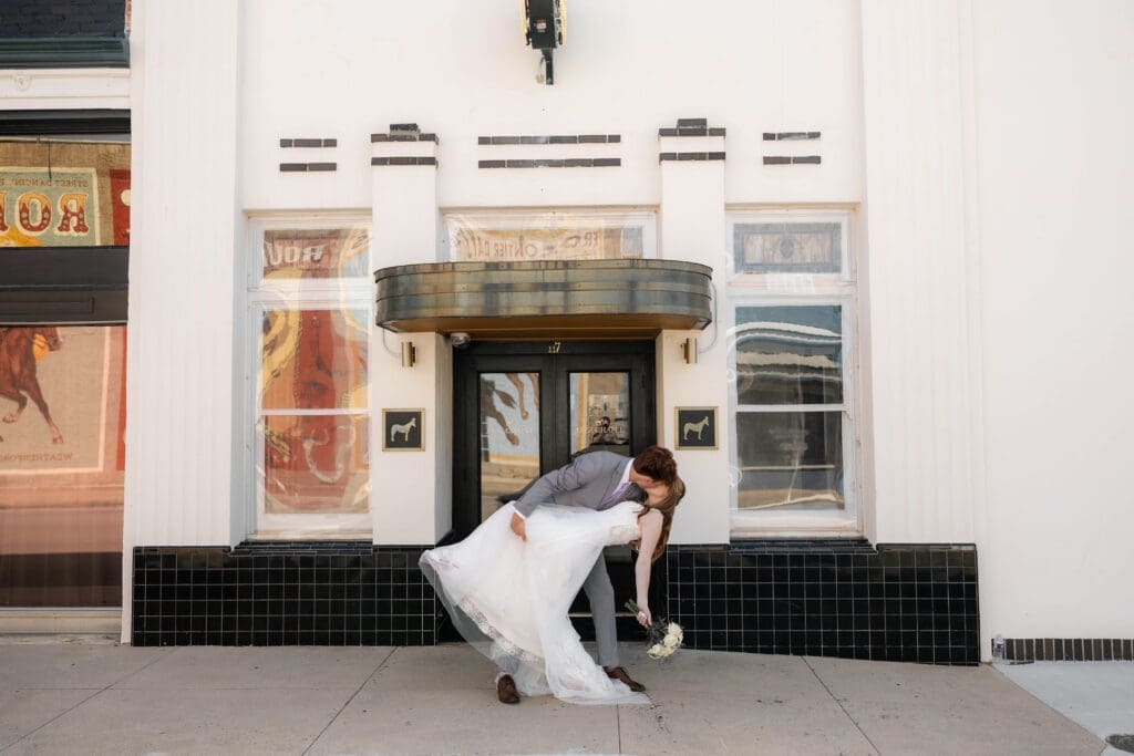 Bride and Groom kissing in front of Jazz Chapel in Downtown Weatherford, TX