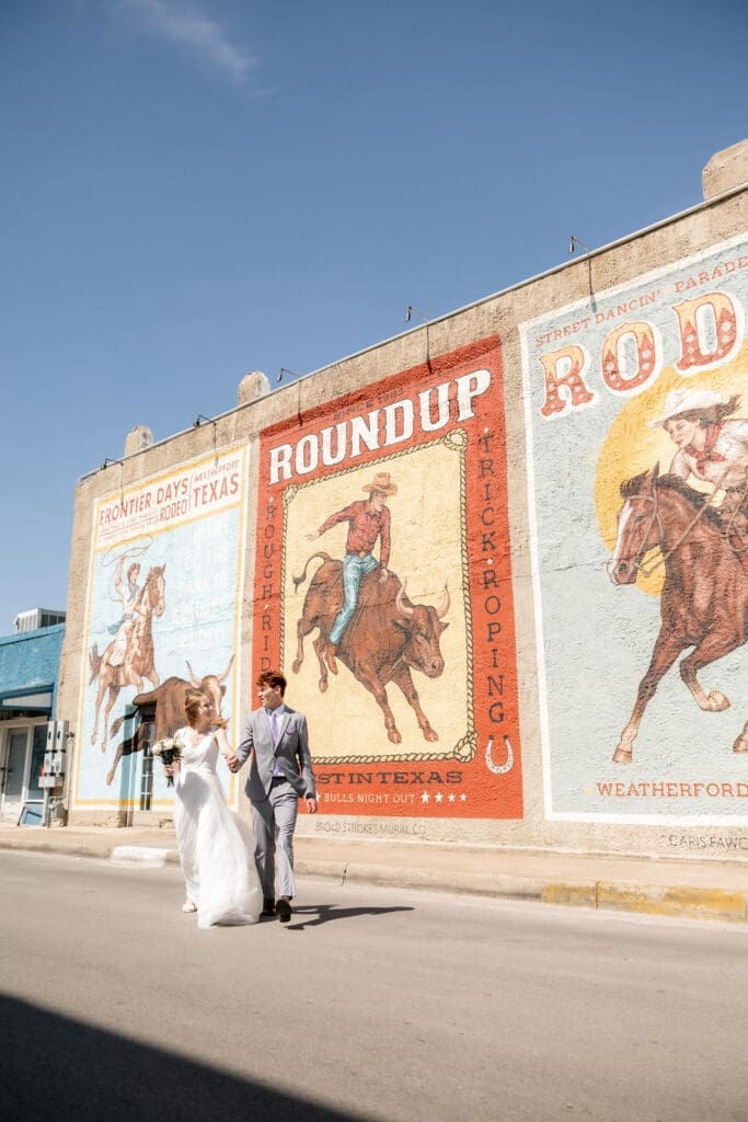 Bride and groom running across the street in downtown Weatherford, TX 