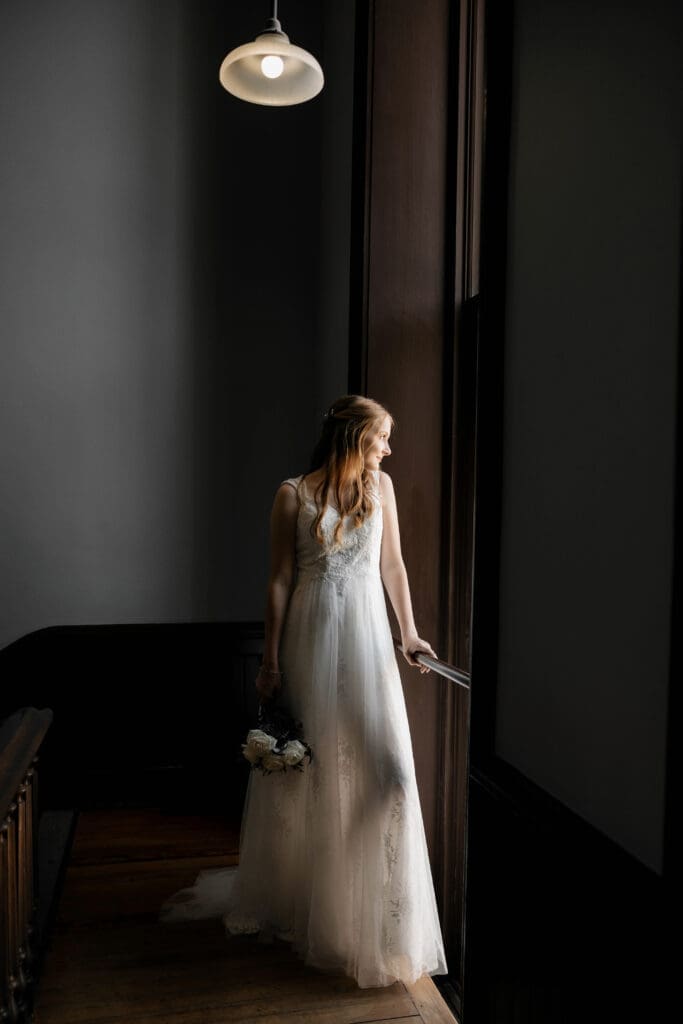 Moody shot of Bride at the Weatherford Courthouse during their elopement
