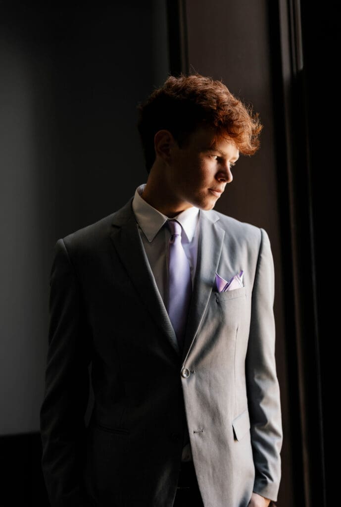 Moody shot of groom at the Weatherford Courthouse during their elopement