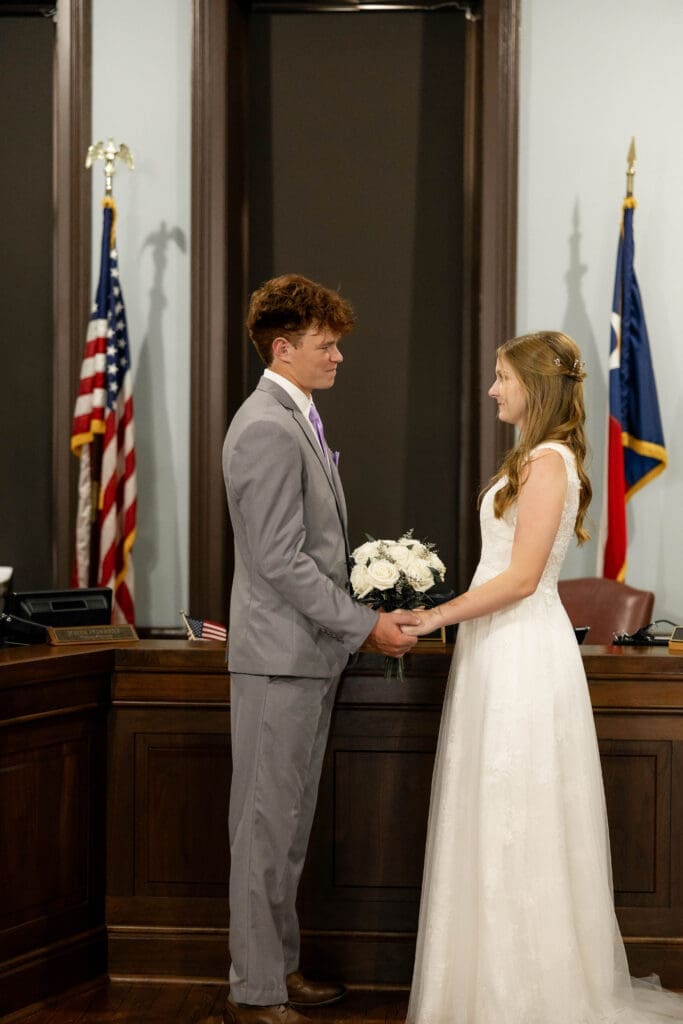 Bride and groom in courthouse courtroom with judge Pat Deen during their Weatherford Courthouse Wedding
