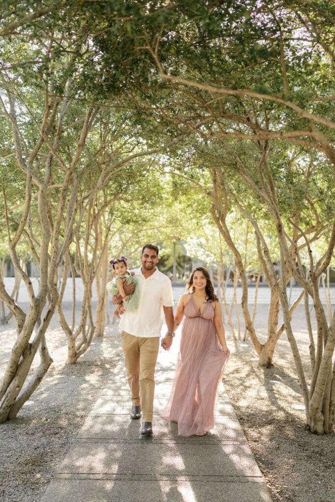 Family standing amongst the crape myrtle trees at Kimbell Art Museum during their family portrait session in Fort Worth