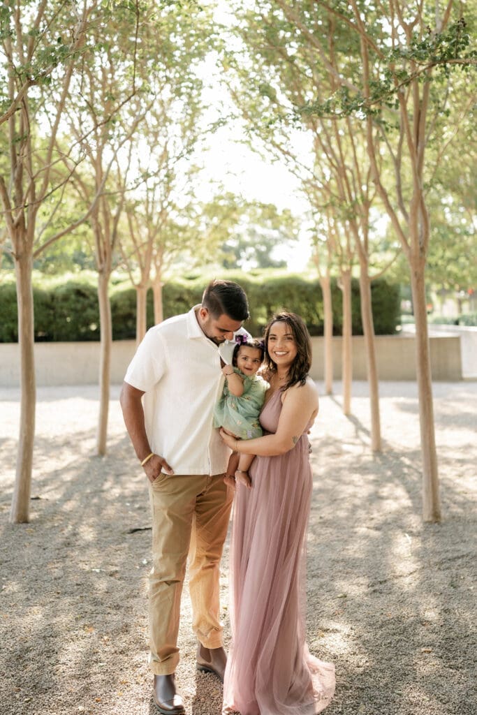 Family standing amongst the crape myrtle trees at Kimbell Art Museum during their family portrait session in Fort Worth